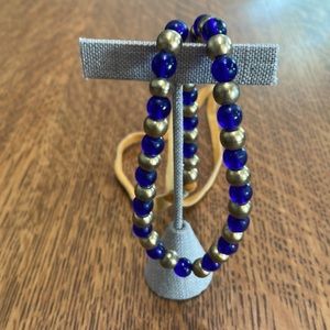 Native American Inspired Indigo and brass beads with deer-hide ties closure. New